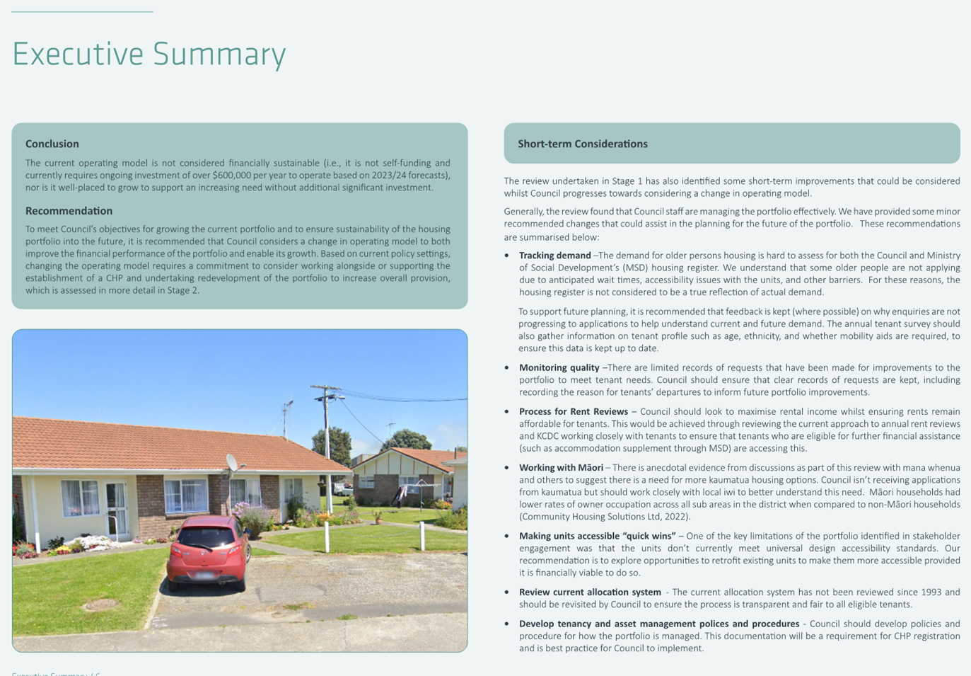 A red car parked in front of a house

Description automatically generated