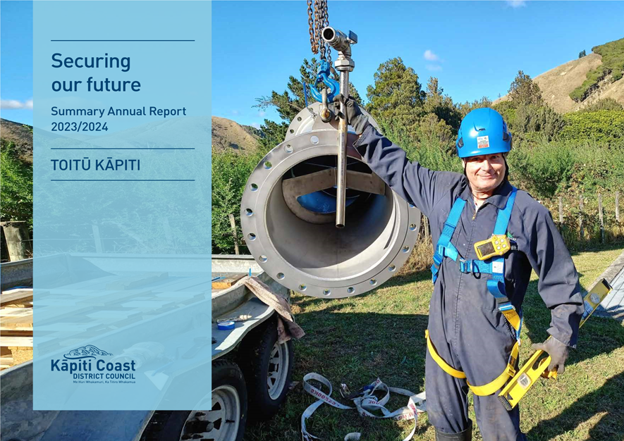A person wearing a blue helmet and harness holding a large pipe

Description automatically generated