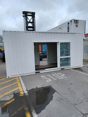 A white container on the street

Description automatically generated